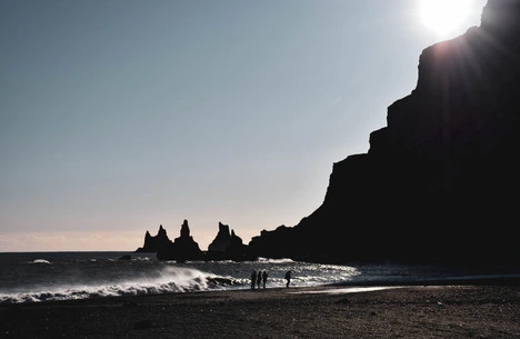 Black sand beach in Iceland with people in foreground